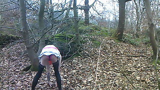 Carla poses and strips for pictures in the woods